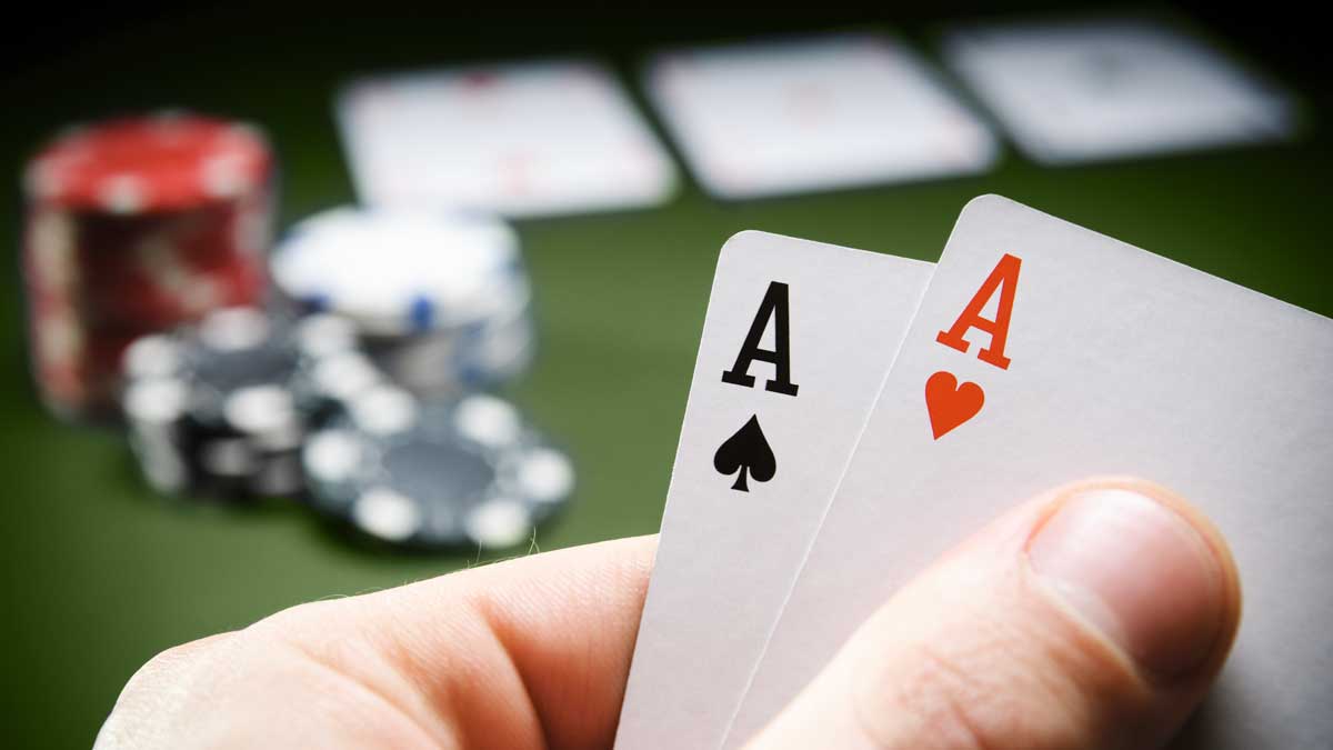 Aces being raised from a poker table